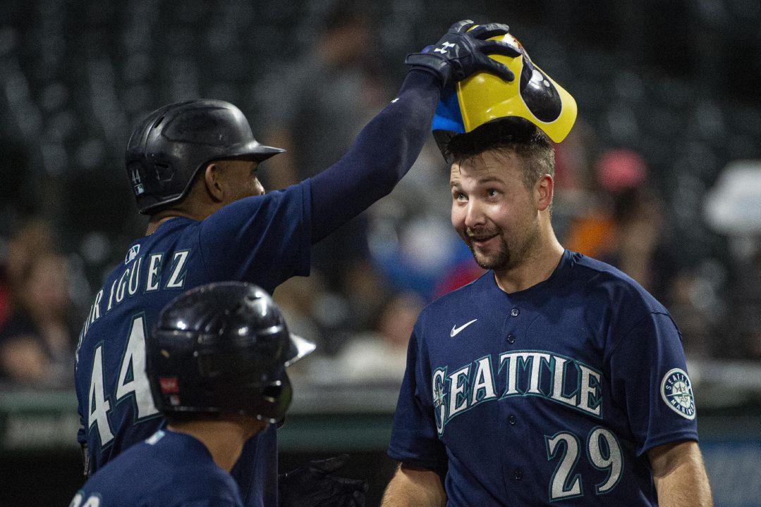 Seattle Mariners' Cal Raleigh gets crowned with the Home Run helmet by Julio  Rodriguez after hitting a two-run home run off Cleveland Guardians relief  pitcher Trevor Stephan during the eleventh inning of